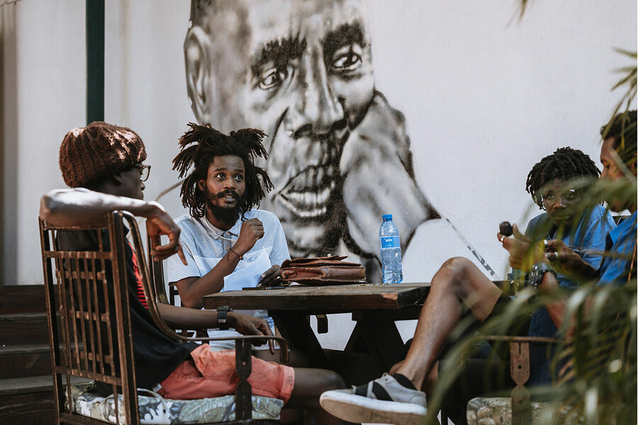 Theatergoers talk after an event at the Yanvalou Café in Port-au-Prince, Haiti. The Quatre Chemins theater festival brings audiences together with Haitian playwrights, actors, and dance companies for readings, staged productions, and street performances.