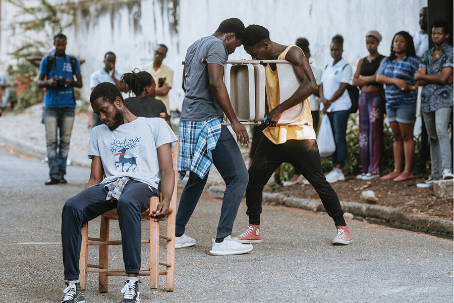 Onlookers take in the street performance of “Inchallah," part of the 19th annual Quatre Chemins theater festival in Port-au-Prince, Haiti.